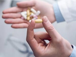 Person Holding Prescription Medications - Defective Drug Lawyers - Martin, Harding & Mazzotti 1800law1010