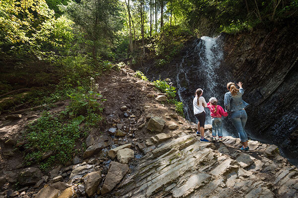 Mother and Two Daughters Hiking at a Waterfall - Brenna's Blog - Hello Spring - Martin, Harding & Mazzotti 1800law1010