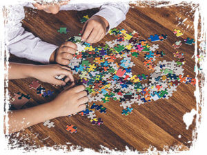 Kids Doing a Puzzle - Brenna's Blog - Rainy Day Activities - Martin, Harding & Mazzotti 1800law1010