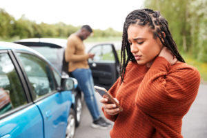 Woman contacting her insurance company after a vehicle accident