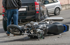 Motorcycle with damage, on its side after an accident