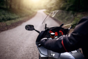 Motorist getting ready to ride their motorcycle down the paved road