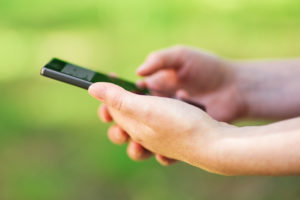 Person on phone gathering and documenting accident information