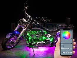 Person holding their phone with an app that controls the custom lighting on their motorcycle