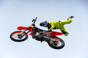 A motorcycle rider performing an aerial stunt