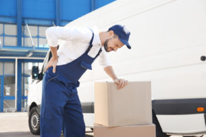 Delivery Worker doubled over in pain while at work