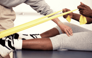 person using exercise band in physical therapy