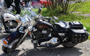 Black motorcycle with custom leather saddlebags for additional cargo