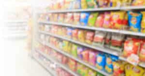 blurred photo of bagged chips section in a grocery store - ultra-processed foods
