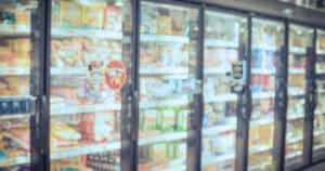 blurred photo of frozen meals section in a grocery store