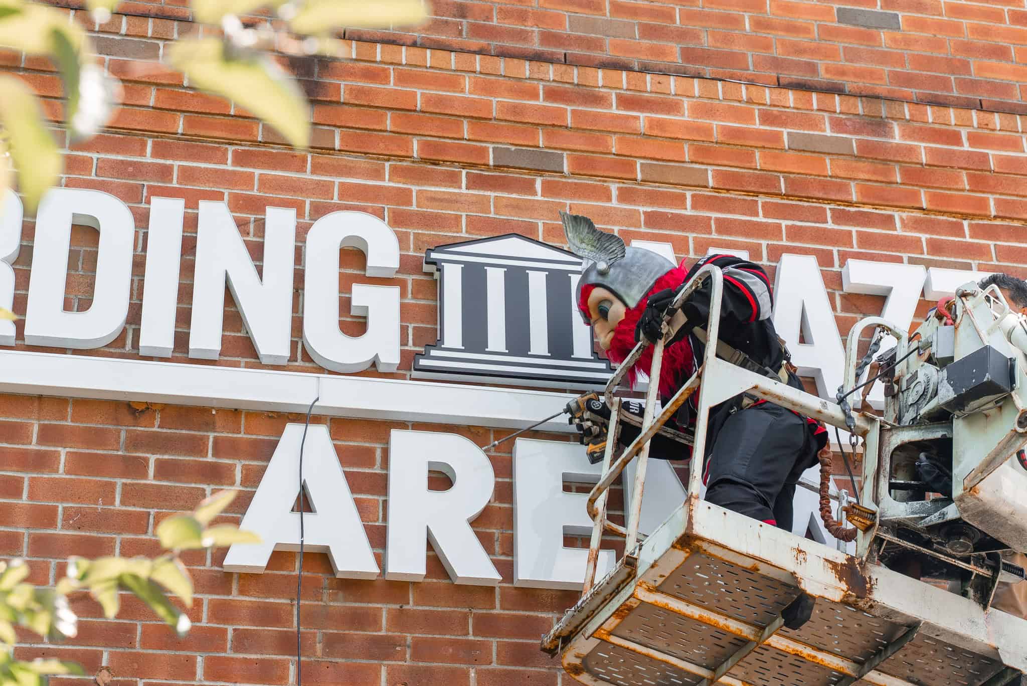 Adirondack Thunder Mascot Gunnar helping put up the Harding Mazzotti Arena sign