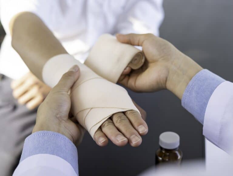 a doctor bandaging someones hand